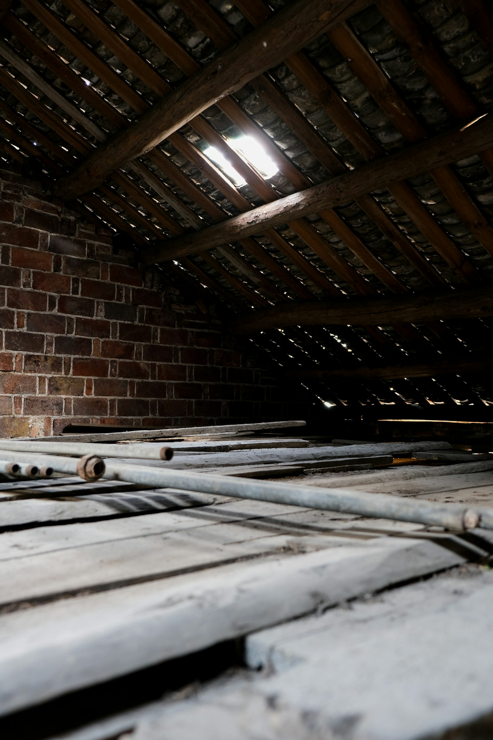 Attic interior showing wooden rafters and ventilation pathways