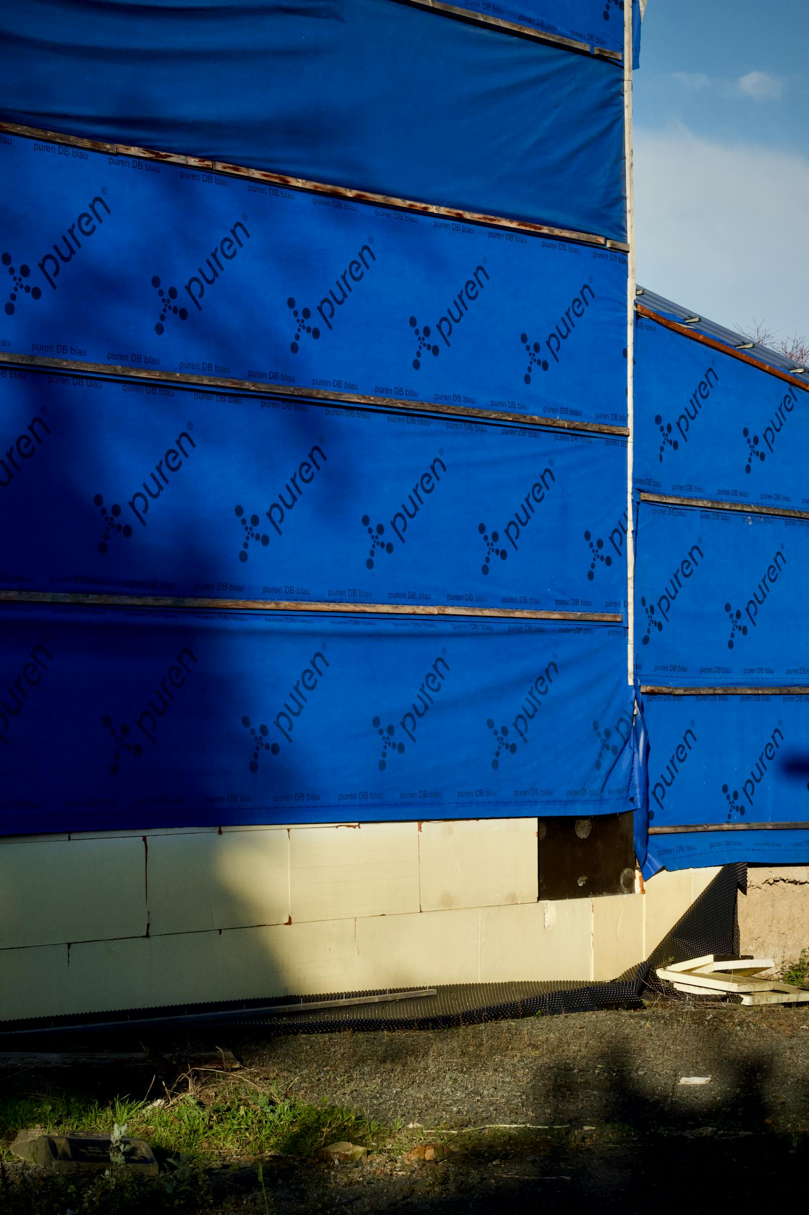 Building under construction with weather barrier wrap installed on the exterior