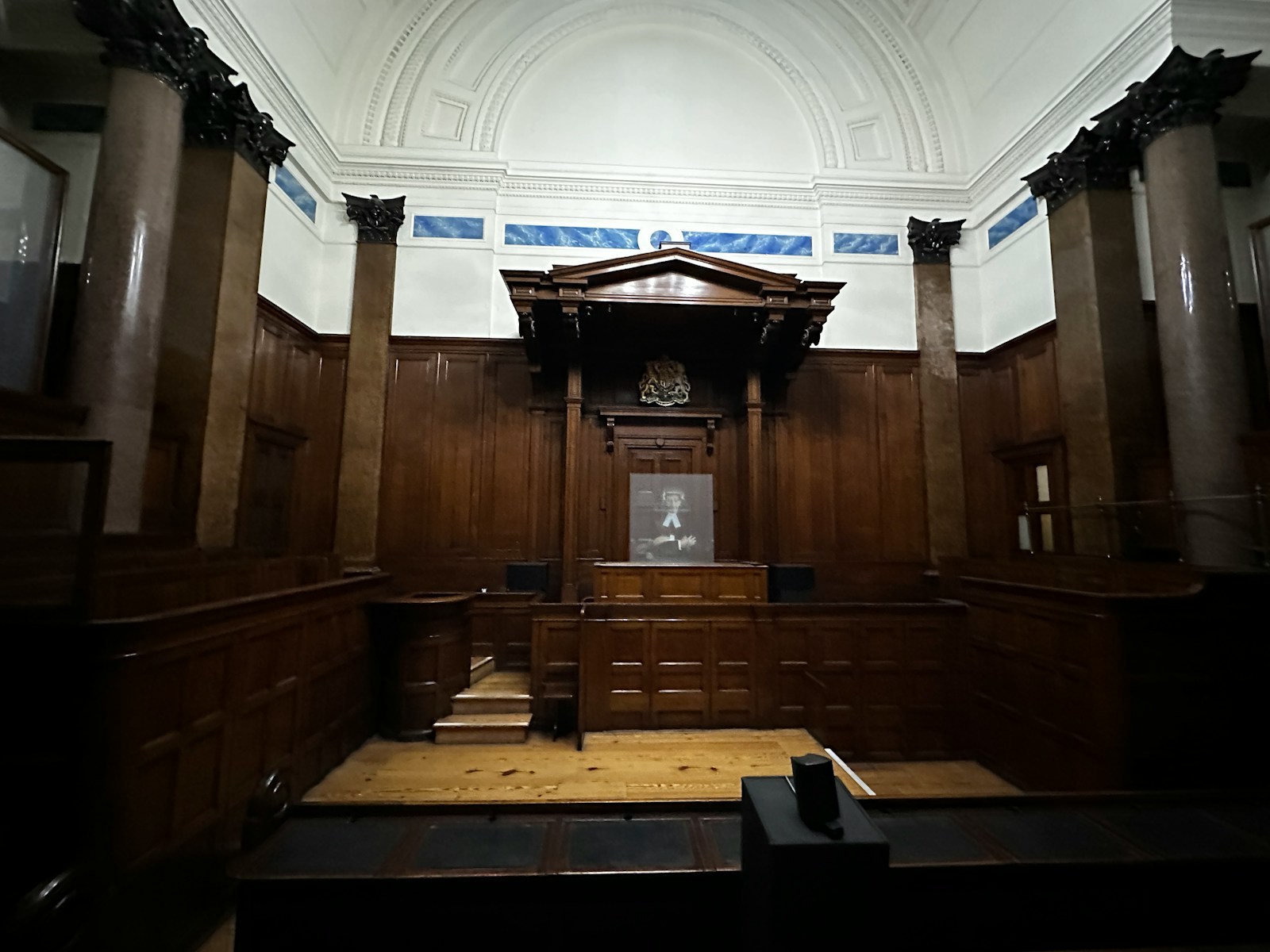Wood-paneled courtroom interior representing expert witness consultation and trial support