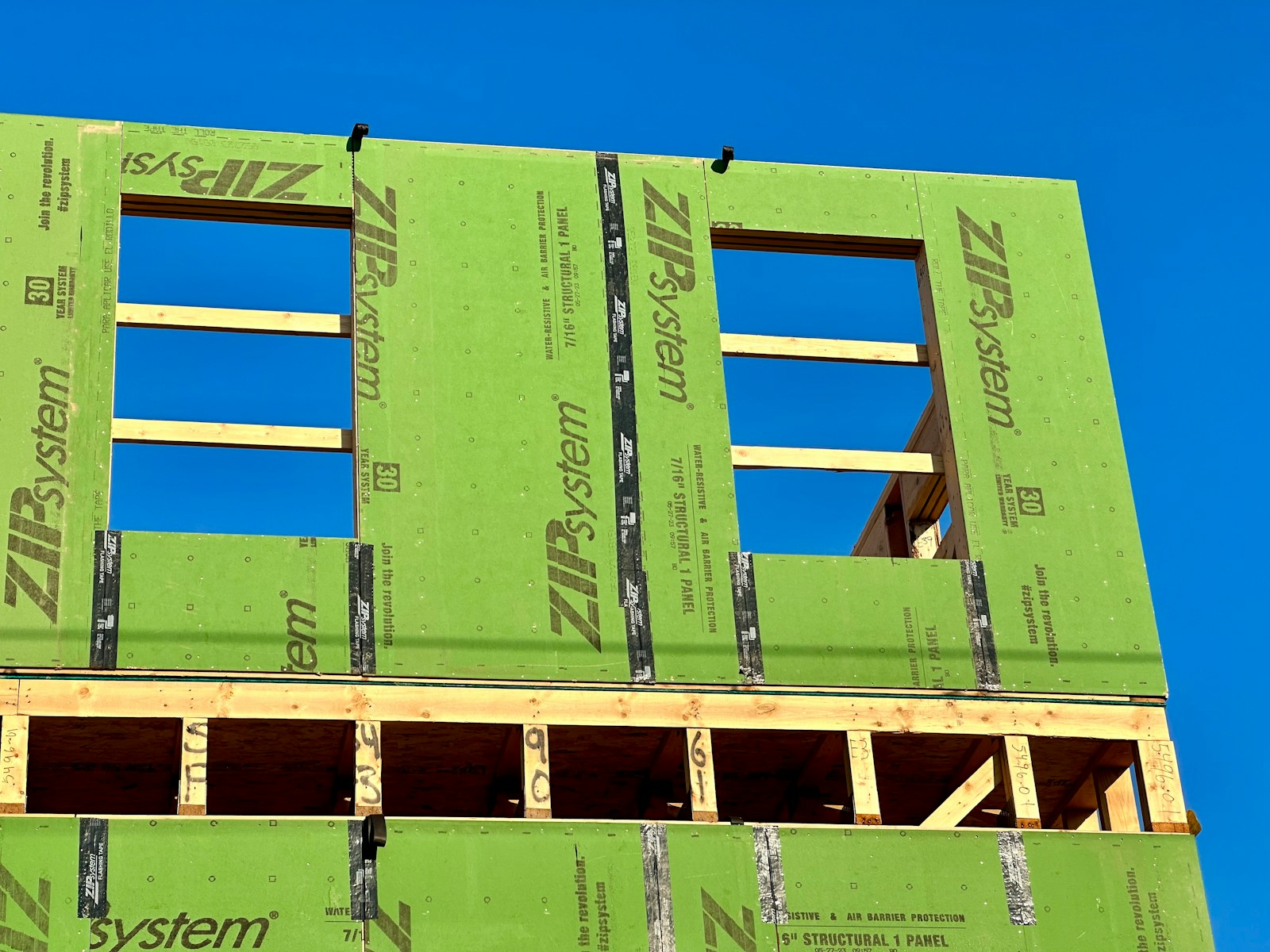Building under construction wrapped with a weather and air barrier