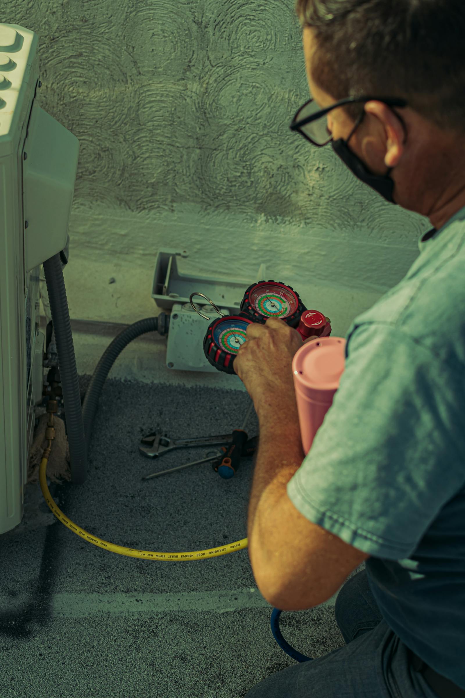 HVAC technician servicing an outdoor air conditioning unit